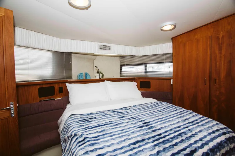 Slide: The Image of Interior of 1991 Carver 36 Aft Cabin Motor Yacht with bed and helm station. - 14