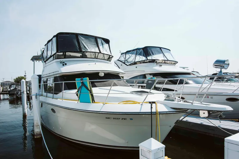Slide: The Image of 1991 Carver 36 Aft Cabin Motor Yacht interior with helm, seating, and decor. - 2