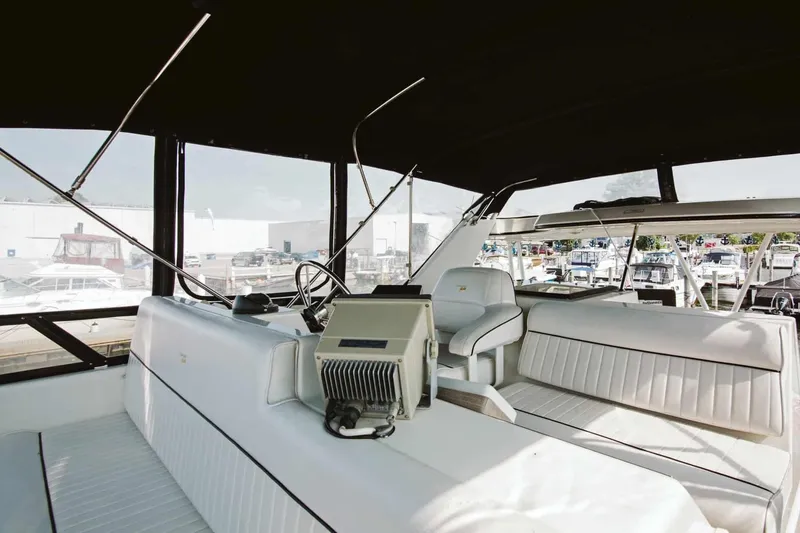 Slide: The Image of Interior view of 1991 Carver 36 Aft Cabin Motor Yacht helm with steering wheel and controls. - 6