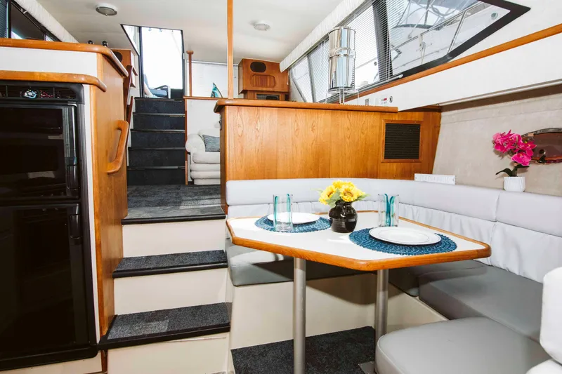 Slide: The Image of 1991 Carver 36 Aft Cabin Motor Yacht interior with steering wheel and marina view. - 8
