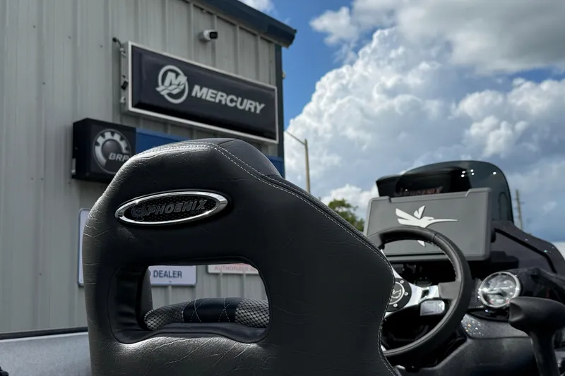 Slide: The Image of 2026 Phoenix 920 ELITE X II boat at Mercury dealership, showcasing sleek design and branding. - 18