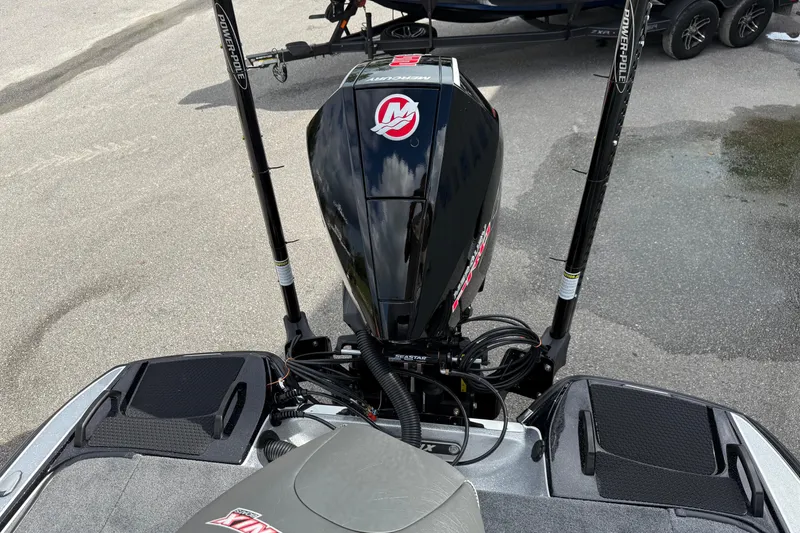 Slide: The Image of 2026 Phoenix 920 ELITE X II boat with powerful engine, parked near dealership. - 20