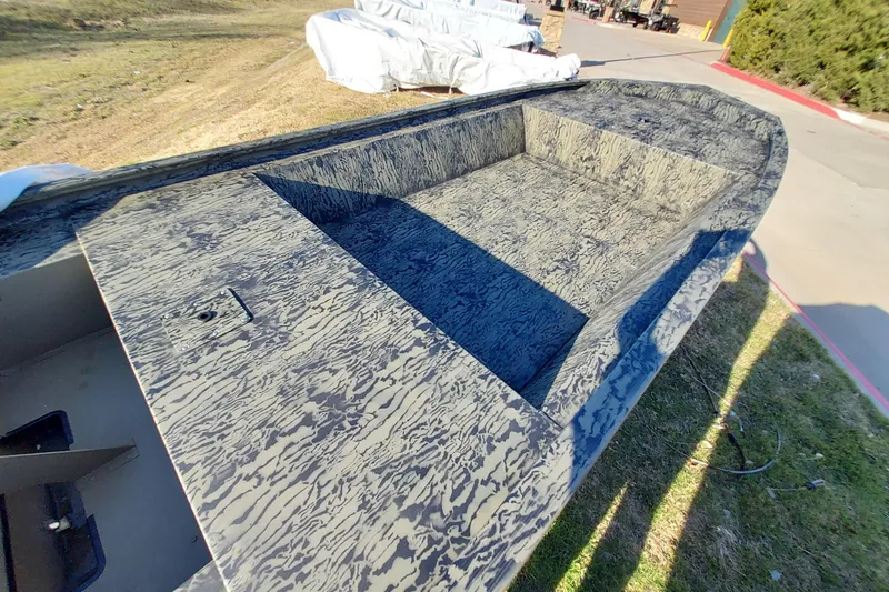 Slide: The Image of 2026 Tracker Grizzly 1648 Utility boat with camouflage pattern, parked outdoors. - 5