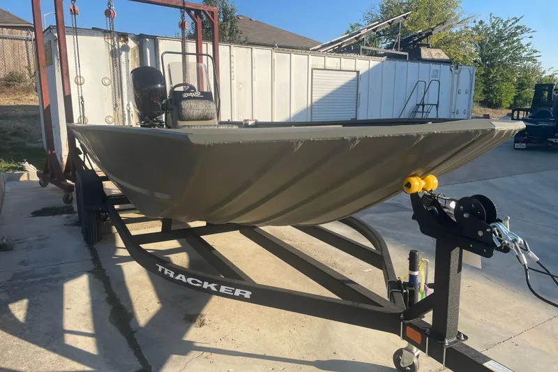 The Image of 2026 Tracker Grizzly 2072 CC boat on trailer, parked outdoors. - 0