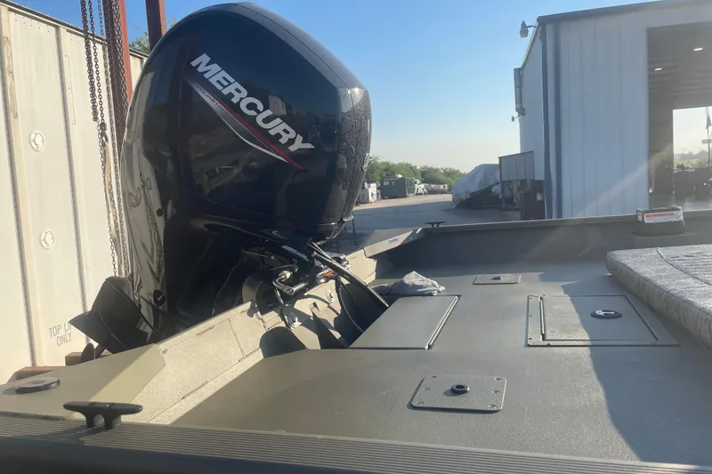 Slide: The Image of 2026 Tracker Grizzly 2072 CC boat with Mercury outboard motor in a sunny outdoor setting. - 4