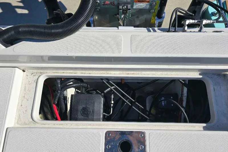 Slide: The Image of Open compartment of 2025 Ranger 2510 Bay boat showing wiring and components. - 18