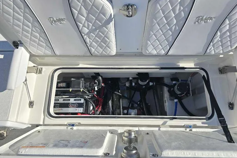 Slide: The Image of 2025 Ranger 2510 Bay boat storage compartment with electrical components and wiring. - 20