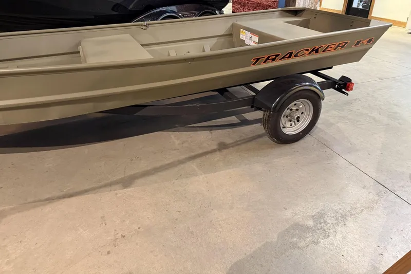 Slide: The Image of 2026 Tracker Grizzly 14 Jon boat on trailer in showroom. - 2