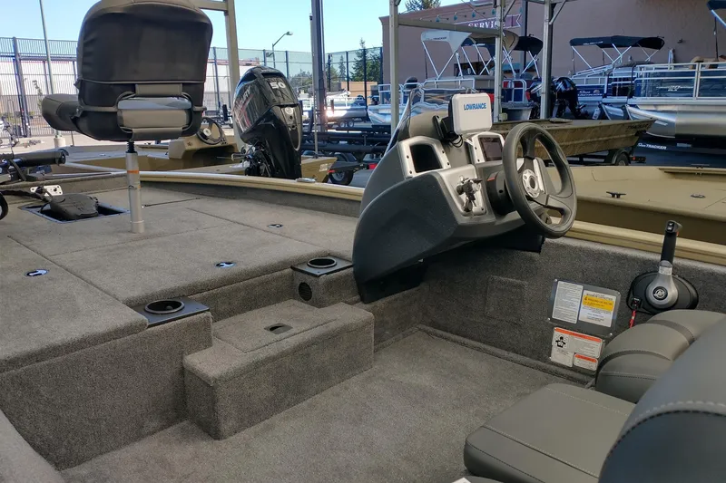 Slide: The Image of 2026 Tracker Pro Team 175 boat interior with steering console and seating. - 3