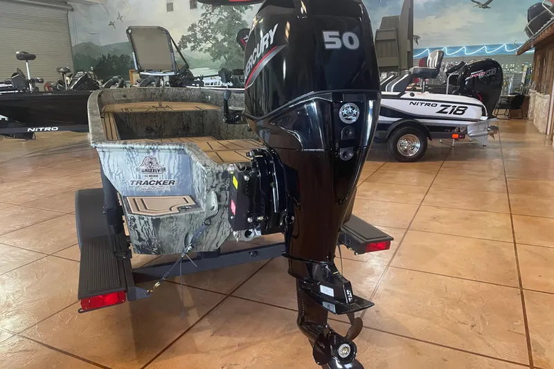 Slide: The Image of 2026 Tracker Grizzly 1650 T Prairie Wings Edition boat with Mercury 50 engine in showroom. - 2