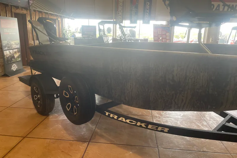 Slide: The Image of 2026 Tracker Grizzly 1650 T Prairie Wings Edition boat on display indoors. - 5