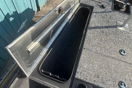 Slide: The Image of Open storage compartment on 2026 Tracker Pro Team 195 boat deck. - 7