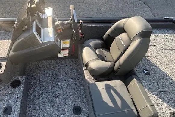 Slide: The Image of 2026 Tracker Pro Team 195 boat interior with gray seating and steering console. - 8