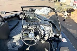 Slide: The Image of 2026 Tracker Targa V-18 Combo boat dashboard with steering wheel and gauges. - 10