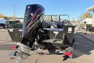 Slide: The Image of 2026 Tracker Targa V-18 Combo boat with powerful outboard motor, parked outdoors. - 12