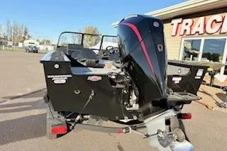 Slide: The Image of 2026 Tracker Targa V-18 Combo boat with powerful outboard motor, parked outdoors. - 13