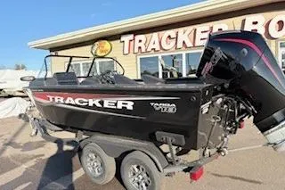 Slide: The Image of 2026 Tracker Targa V-18 Combo boat on trailer outside dealership. - 14