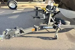 Slide: The Image of 2026 Tracker Targa V-18 Combo boat trailer hitch on pavement. - 16