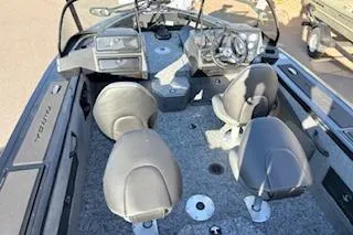 Slide: The Image of 2026 Tracker Targa V-18 Combo boat interior with seating and steering console. - 6