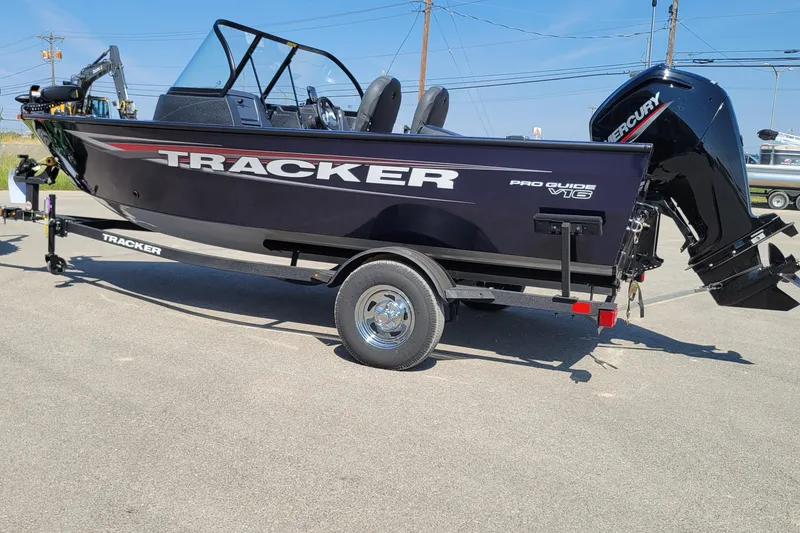 Slide: The Image of 2026 Tracker Pro Guide V-16 WT boat on trailer, featuring sleek design and Mercury outboard motor. - 2