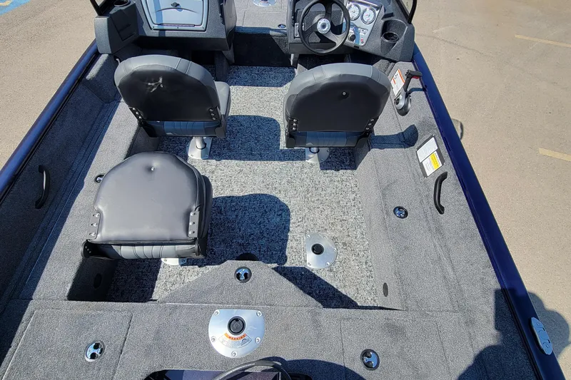 Slide: The Image of 2026 Tracker Pro Guide V-16 WT boat interior with seating and steering console. - 3