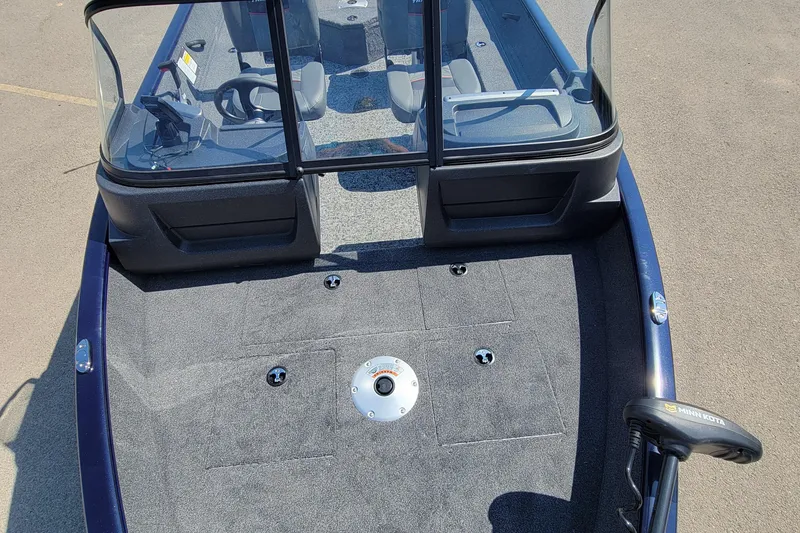 Slide: The Image of 2026 Tracker Pro Guide V-16 WT boat interior with seating and Minn Kota trolling motor. - 4