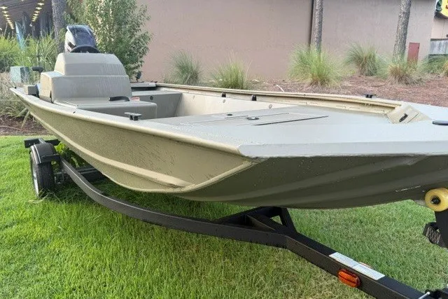 Slide: The Image of 2026 Tracker Grizzly 1648 SC boat on trailer, parked on grass. - 2