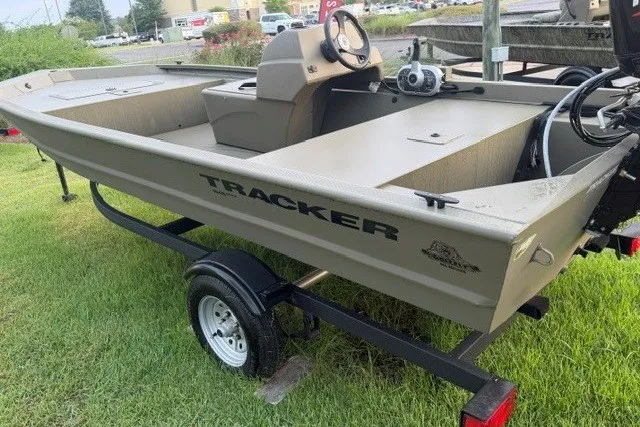 The Image of 2026 Tracker Grizzly 1648 SC boat on trailer, parked on grass. - 0