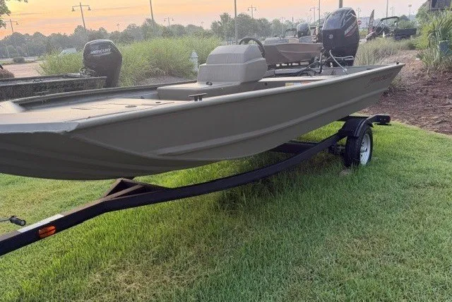 Slide: The Image of 2026 Tracker Grizzly 1648 SC boat on trailer, parked on grass. - 3