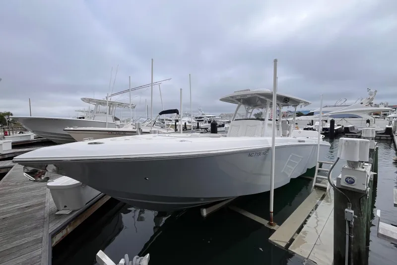 The Image of 2025 Fountain 34 CC boat docked at marina under cloudy sky. - 1