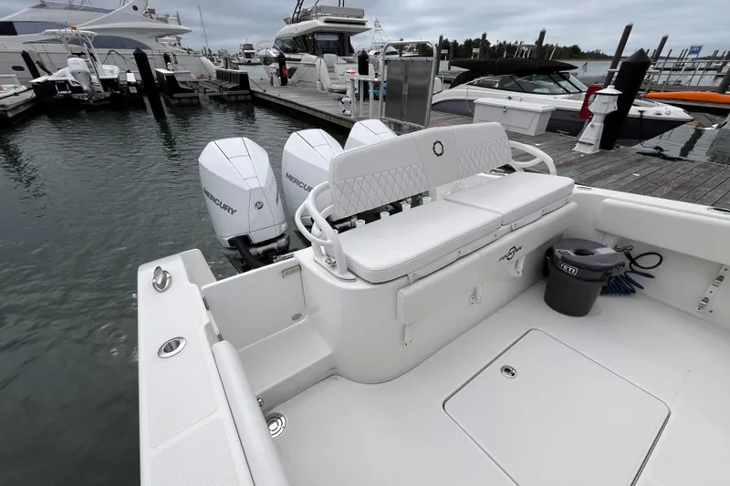 Slide: The Image of 2025 Fountain 34 CC boat docked, featuring twin Mercury engines and spacious seating. - 14