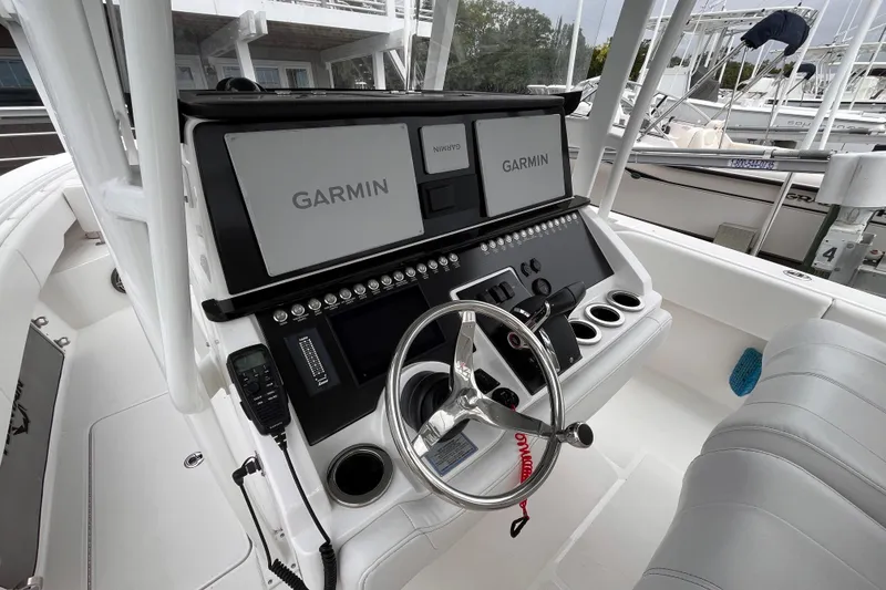 Slide: The Image of 2025 Fountain 34 CC boat cockpit with Garmin navigation system and steering wheel. - 17