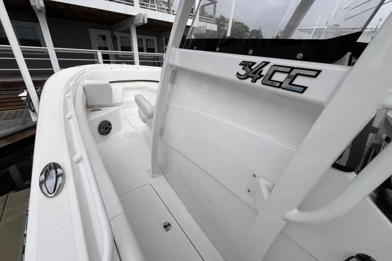 Slide: The Image of 2025 Fountain 34 CC boat interior, showcasing sleek white design and seating area. - 18