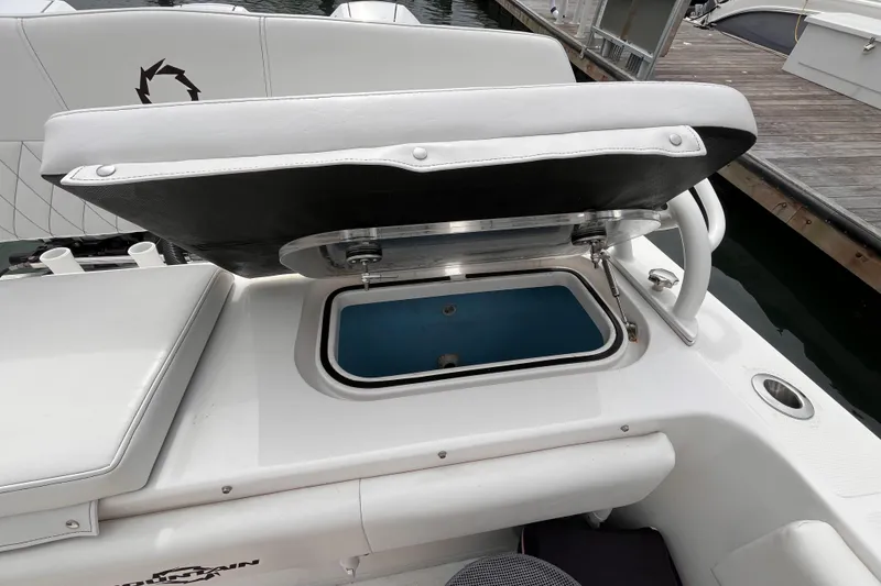 Slide: The Image of Open storage compartment on 2025 Fountain 34 CC boat, docked at marina. - 21