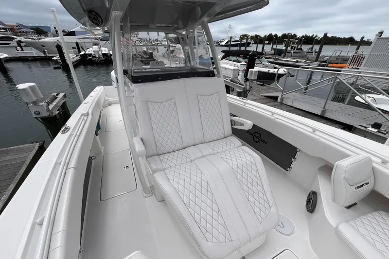 Slide: The Image of 2025 Fountain 34 CC boat with luxurious seating at a marina. - 9