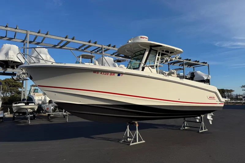 The Image of 2021 Boston Whaler 280 Outrage boat on stands, clear sky background. - 1