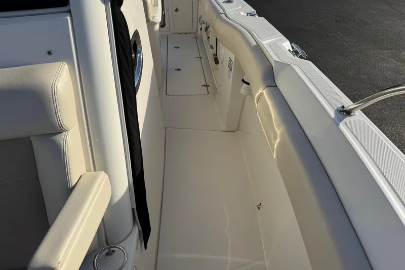 Slide: The Image of Interior view of a 2021 Boston Whaler 280 Outrage boat, showcasing sleek seating and deck design. - 10