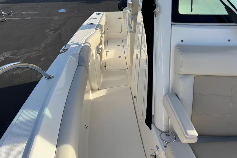 Slide: The Image of 2021 Boston Whaler 280 Outrage boat interior with white seating and sleek design. - 11