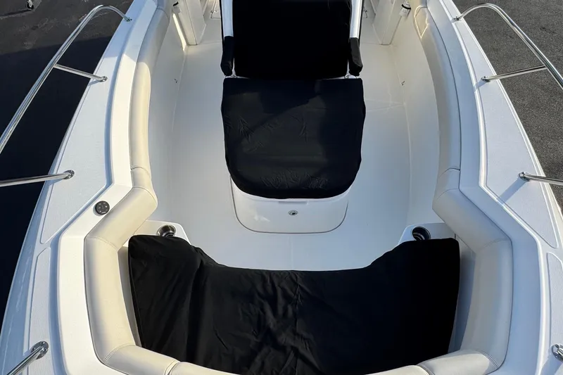 Slide: The Image of 2021 Boston Whaler 280 Outrage boat interior with cushioned seating and stainless steel railings. - 19