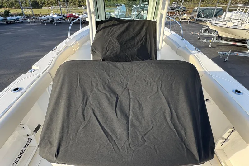 Slide: The Image of 2021 Boston Whaler 280 Outrage boat interior with covered seating, docked outdoors. - 20