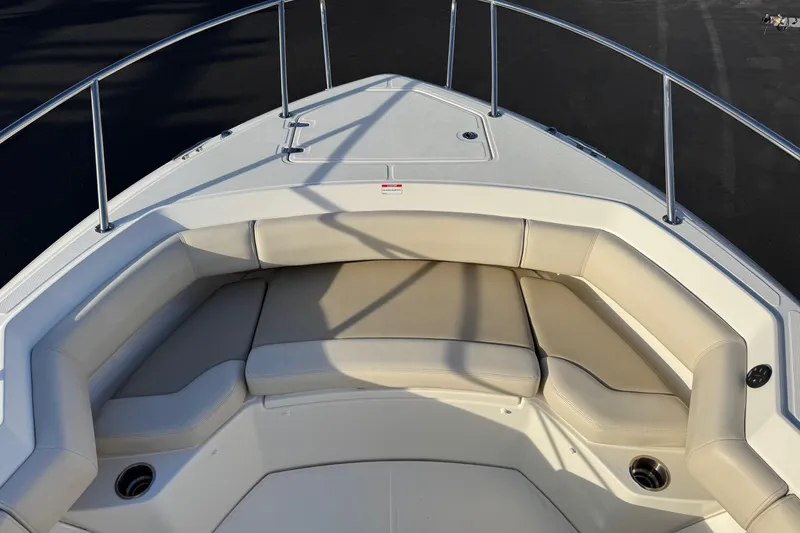 Slide: The Image of Bow seating area of a 2021 Boston Whaler 280 Outrage boat with beige cushions. - 5