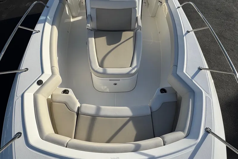 Slide: The Image of 2021 Boston Whaler 280 Outrage boat interior with cushioned seating and stainless steel railings. - 7