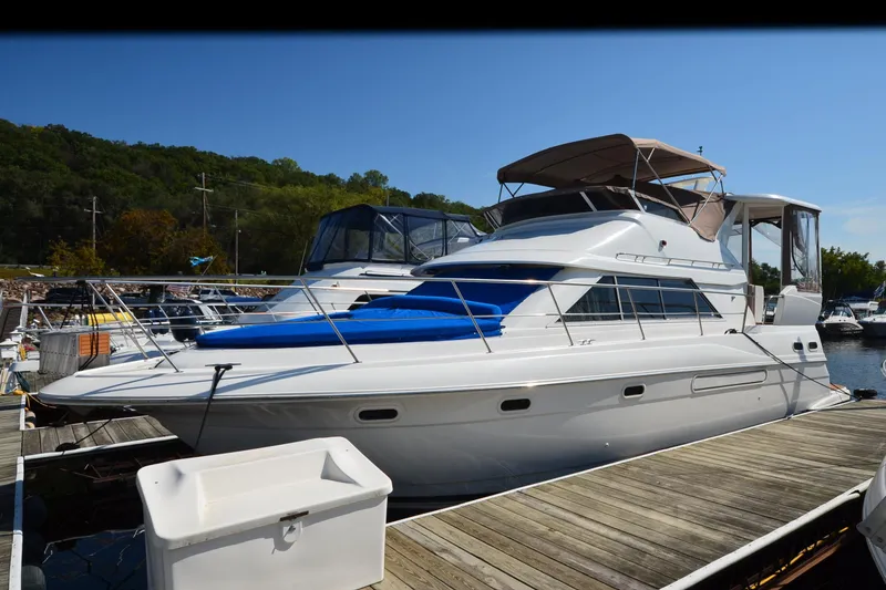 The Image of 2001 Cruisers Yachts 3750 Motoryacht docked at marina, featuring sleek design and spacious deck. - 0