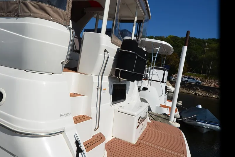 Slide: The Image of 2001 Cruisers Yachts 3750 Motoryacht docked, showcasing sleek design and spacious deck. - 10