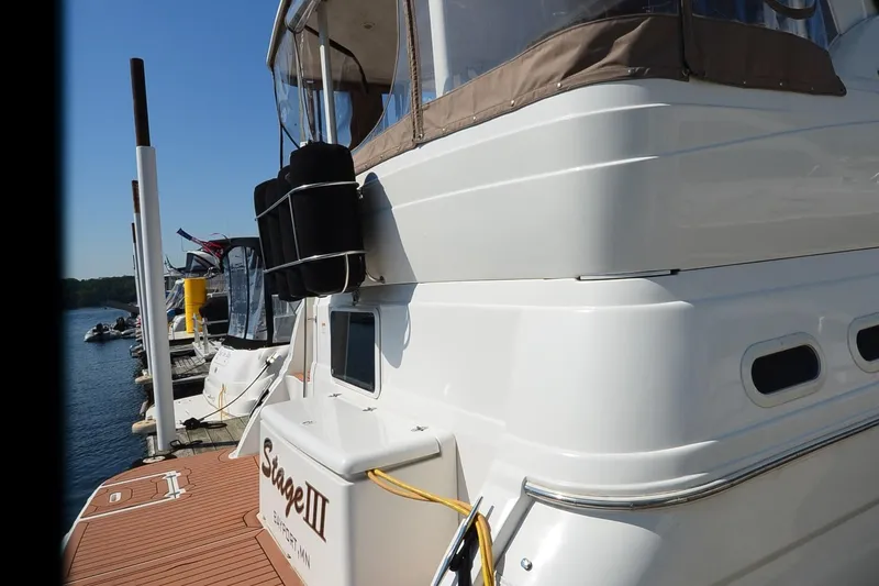 Slide: The Image of 2001 Cruisers Yachts 3750 Motoryacht docked, showcasing sleek design and spacious deck. - 11