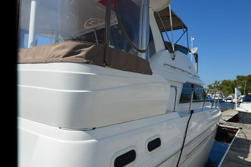 Slide: The Image of 2001 Cruisers Yachts 3750 Motoryacht docked under clear blue sky. - 12