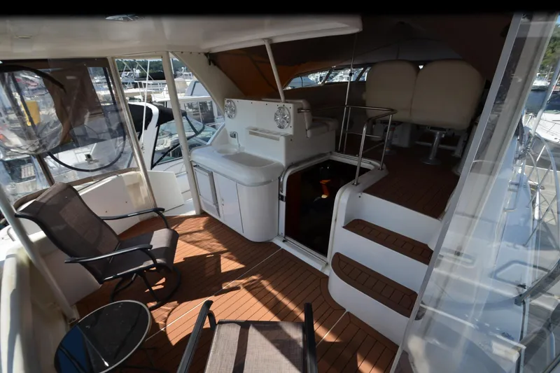 Slide: The Image of 2001 Cruisers Yachts 3750 Motoryacht interior with seating and stairs, featuring a sleek design. - 15