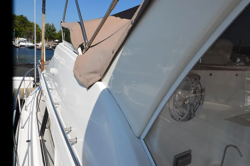 Slide: The Image of 2001 Cruisers Yachts 3750 Motoryacht side view with canopy, docked at marina. - 16