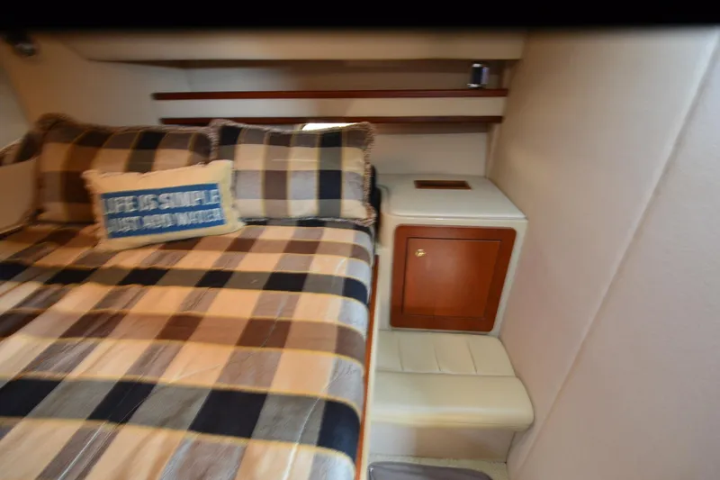 Slide: The Image of Cozy bedroom in 2001 Cruisers Yachts 3750 Motoryacht with plaid bedding and decorative pillow. - 22