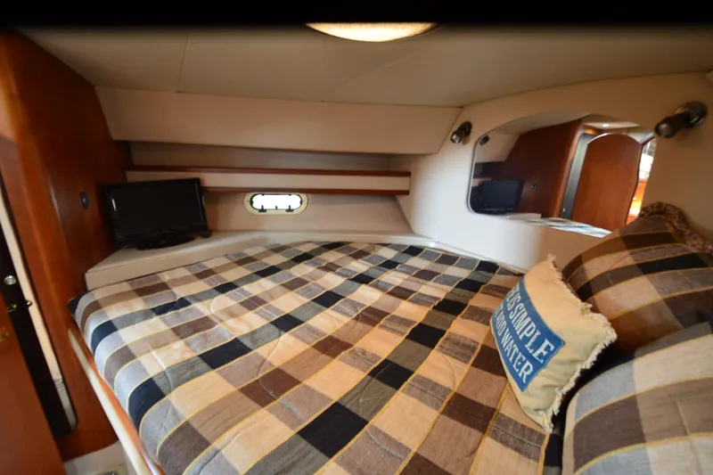 Slide: The Image of Interior cabin of 2001 Cruisers Yachts 3750 Motoryacht with plaid bedding and TV. - 23